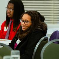 Female student listens to speakers at Pave the Way